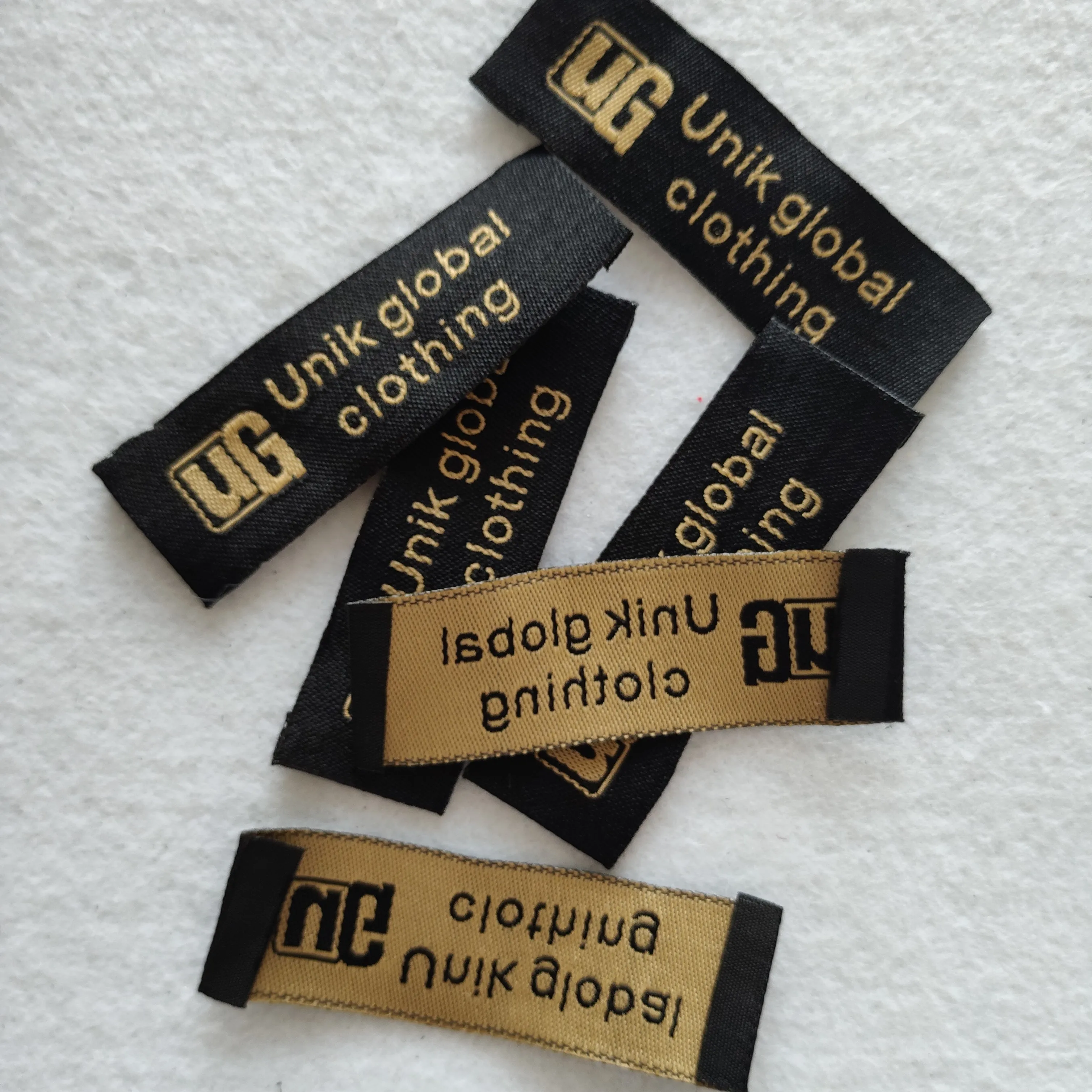 

Wholesale High quality black background and gold logo clothing tags neck woven label, Custom color