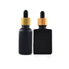 high quality 1 oz 30ml round shape 30 ml matte frosted black rectangular glass dropper bottle with bamboo lids for essential oil