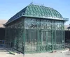 Large wrought iron gazebo with metal solid roof and glass to keep rain out, metal sunroom