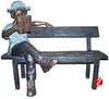 Little bronze children reading statue sitting on a bench