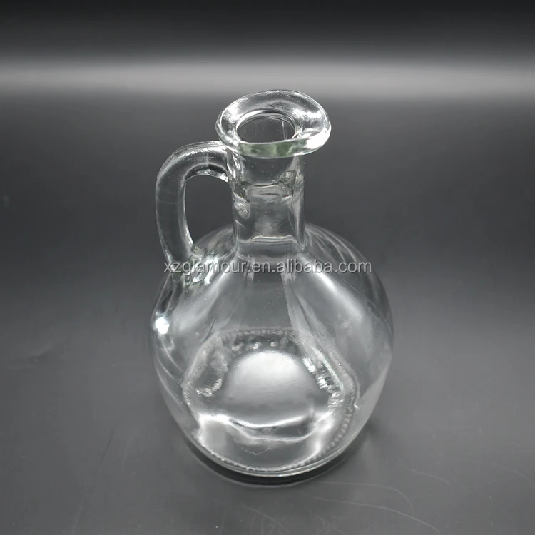 
clear glass pot dispenser with bird beak for olive oil or vinegar 