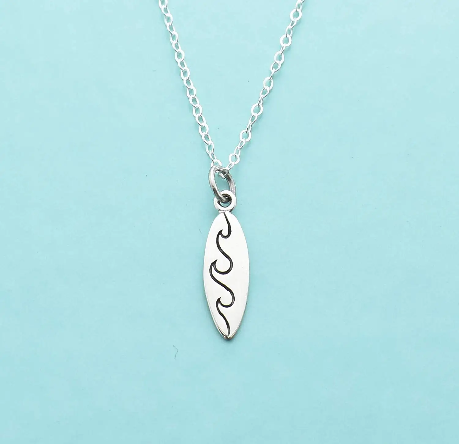Sterling Silver Surfboard With Inlaid Paua Shell Wave Design Pendant