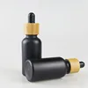 Customized 10ml 20ml 30ml 50ml 100ml empty package essential oil using Matte black glass dropper bottle with bamboo lid