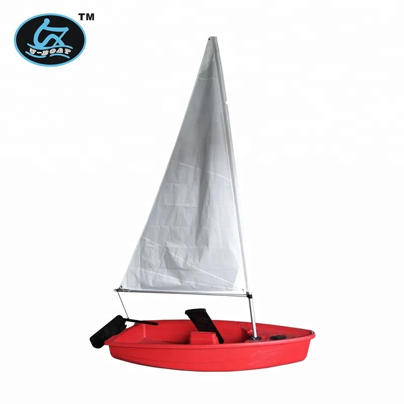 
small optimist student sailboat sails with outrigger 