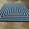 Handmade clear blue and black vertigo rug