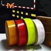 Colored reflective glass bead material for safety prismatic reflective film