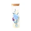 glass bottle with wooden stopper in hydrangea and preserved flower