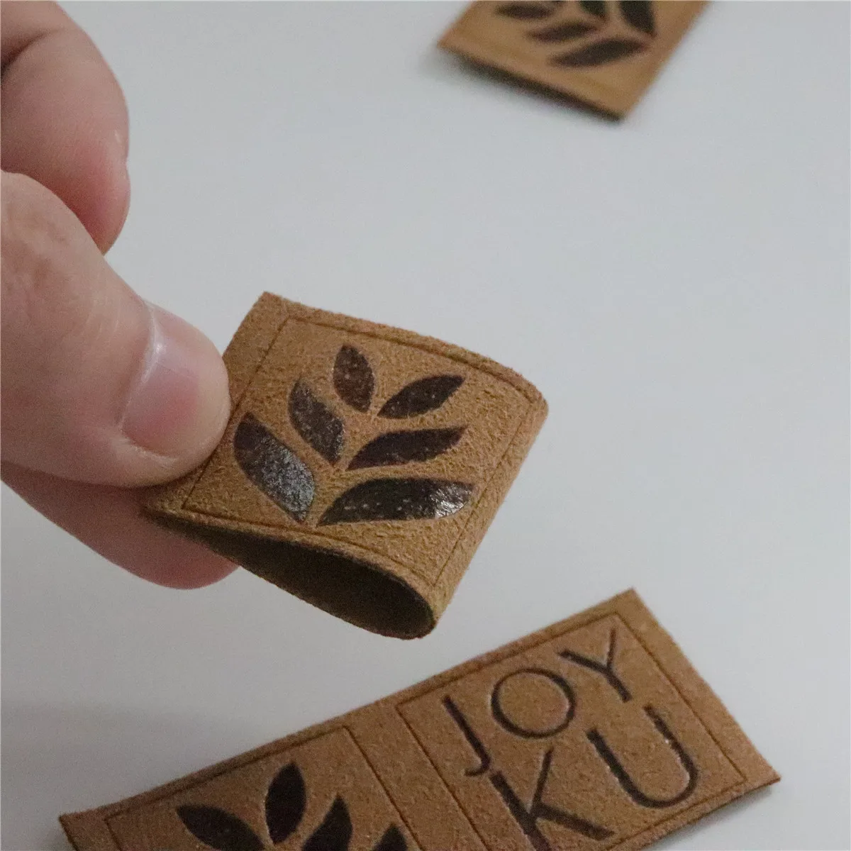 

Wholesale Custom LOGO Folded Suede Leather Label For Hats/Clothing/garment