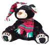 beautiful black furry Thumbles Christmas teddy bear dressed with a tartan hat, scarf holding a candy stick, with holly on hat