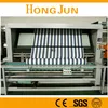 Knit fabric open width slitting and rolling machines