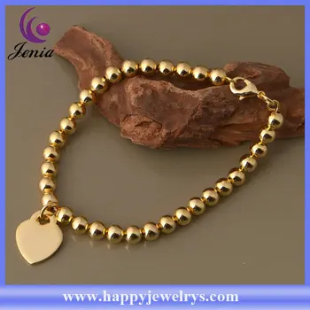 gold bracelet with heart charm