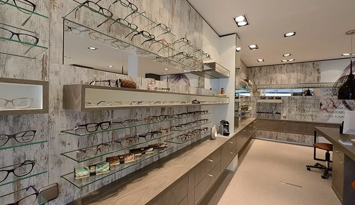 Branded eyewear retail shop wood display counter and glass shelving for sunglasses display
