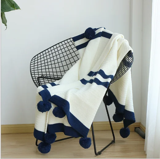 

Nordic cotton knitted blanket in winter with pom pom