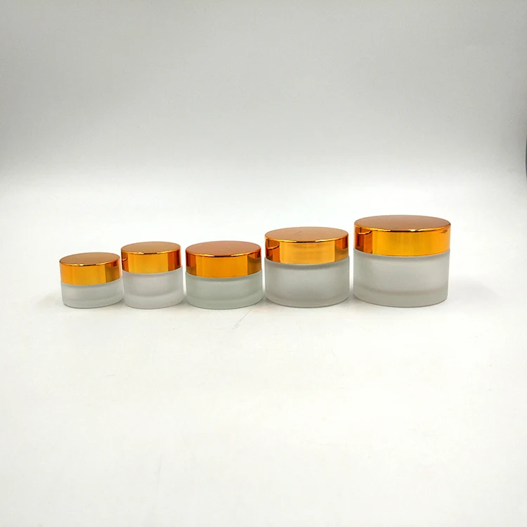 Sample size straight side 8g glass cosmetic jar with matte surface handing