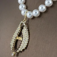 

Wholesale custom white pearl necklace with DST delta sigma theta gold rhinestone wing charms greek sorority pearl necklace