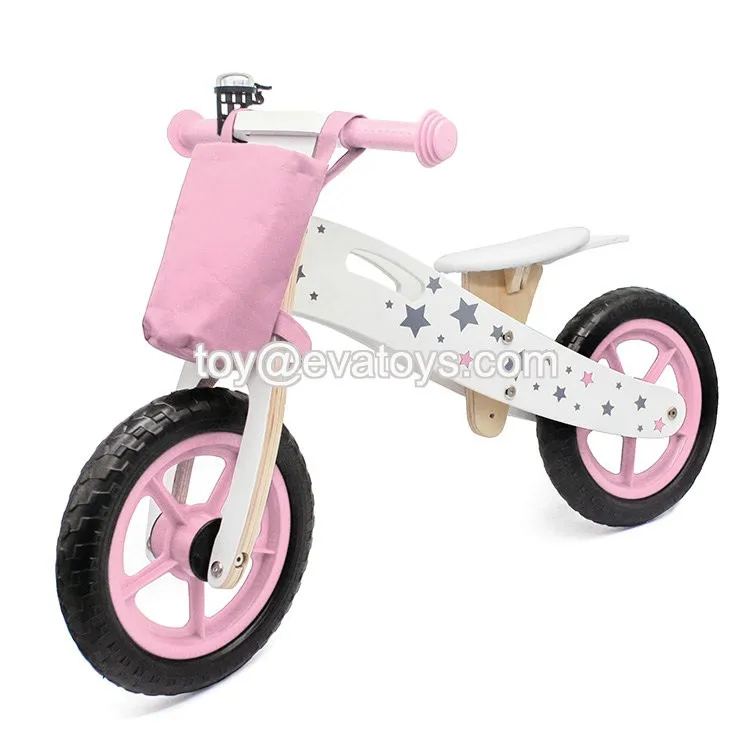 pink wooden balance bike