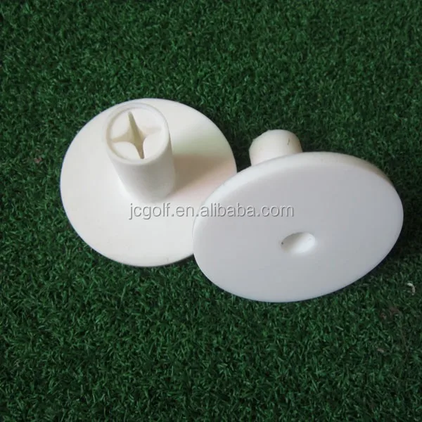 

White rubber golf tee holders for driving range mats