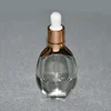 Luxury cosmetic packaging bottle 15ml 30ml oval shape unique glass dropper bottle