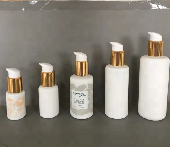 

cosmetic opal white round shoulder cream glass bottle with gloss gold pump