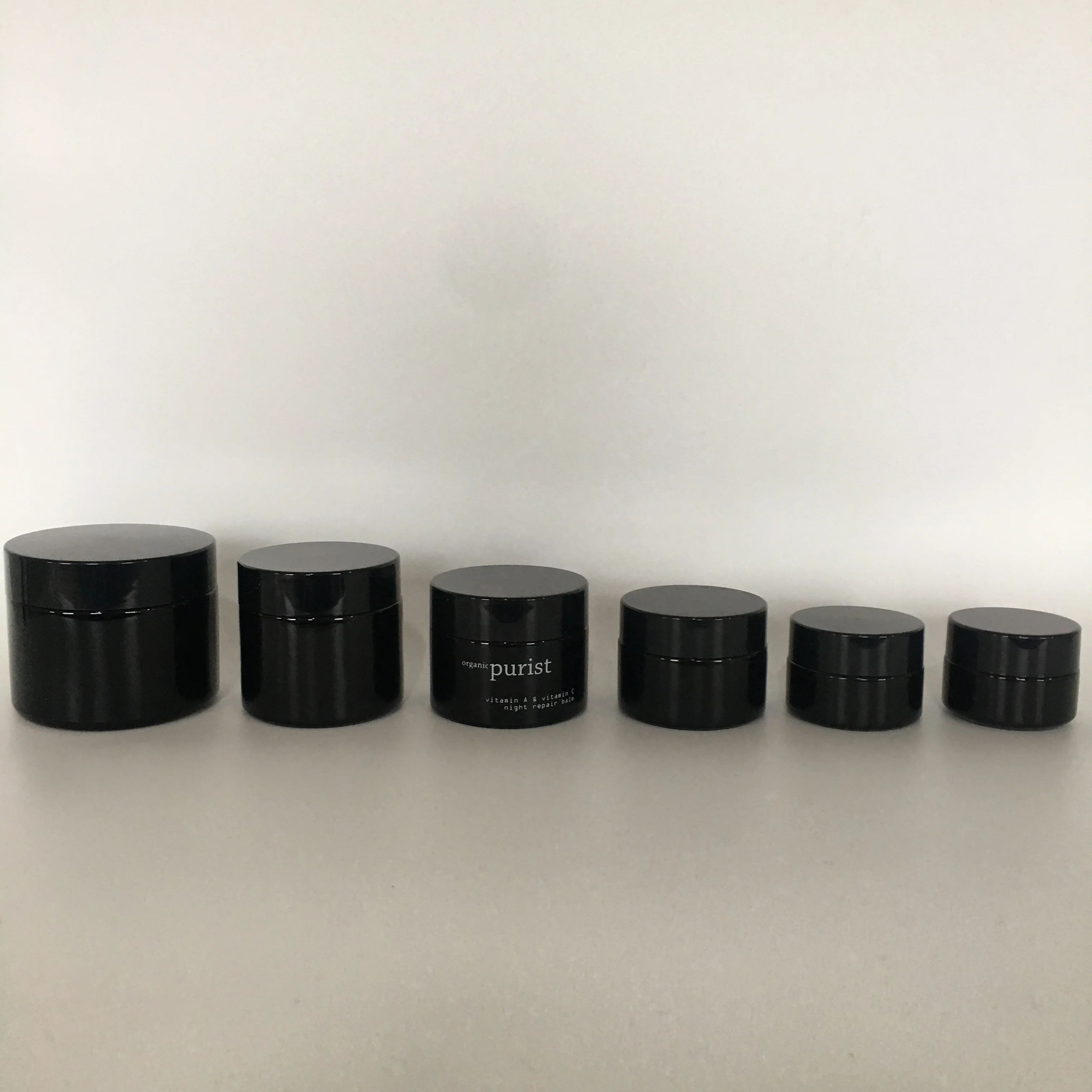 

Factory hot sale cosmetic round gloss black lotion glass jar with black lid
