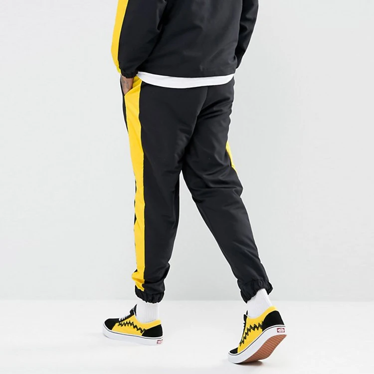 yellow joggers with black stripe