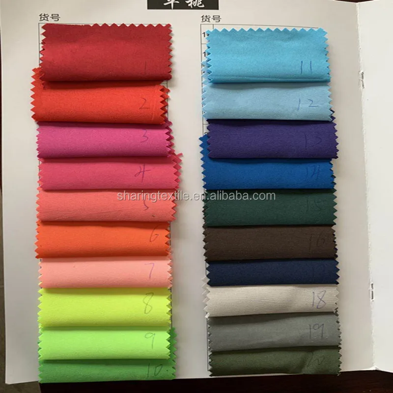 
100% Polyester Peach Skin Fabric /Micro Fiber Fabric 100Gsm 75D*150D Stock Lot Plain Peach Skin Fabric For Beach Shorts 