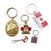 Latest design odd shape antique brass gold pressure casting emblem gravity painted Canadian Maple Leaf commemorative Key Chains