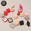 Pyramid shape fabric cover button with metal rivets