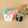/product-detail/small-lovely-fancy-recycled-printed-gift-packaging-promotional-paper-bag-with-ribbon-bow-tie-62200790833.html