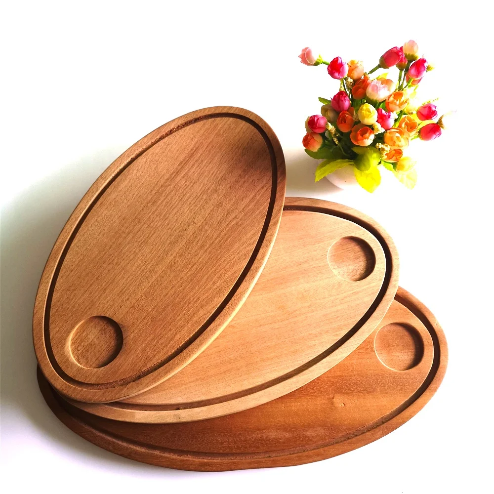 

Oval shape sapele cutting board with groove, Natural wood color