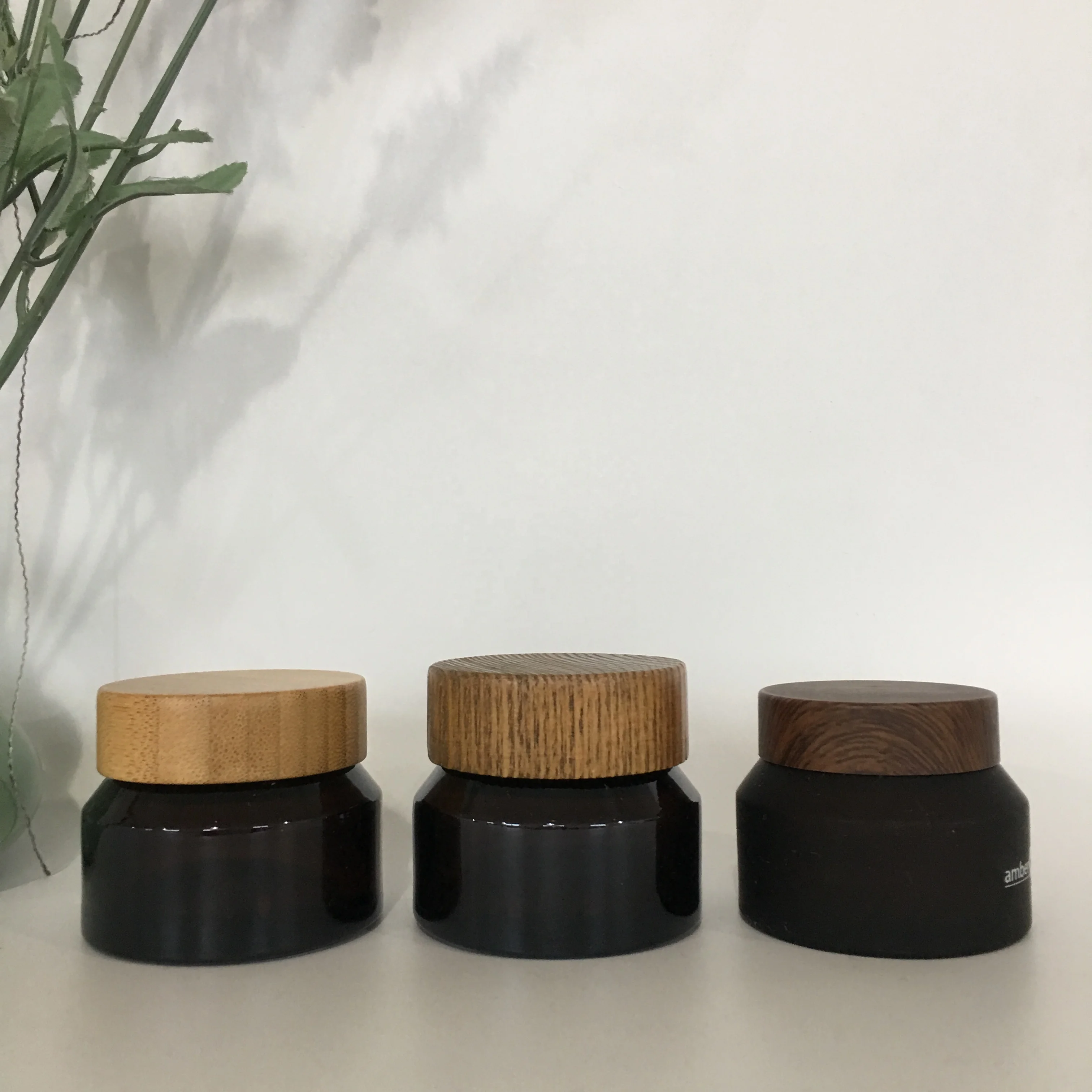 

Factory hot sale 50g amber lotion glass jar with bamboo plastic and wood lid