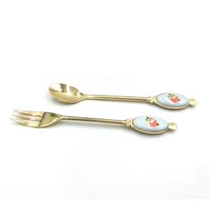 Image of Flower ceramic piece handle fork and knife set in gold