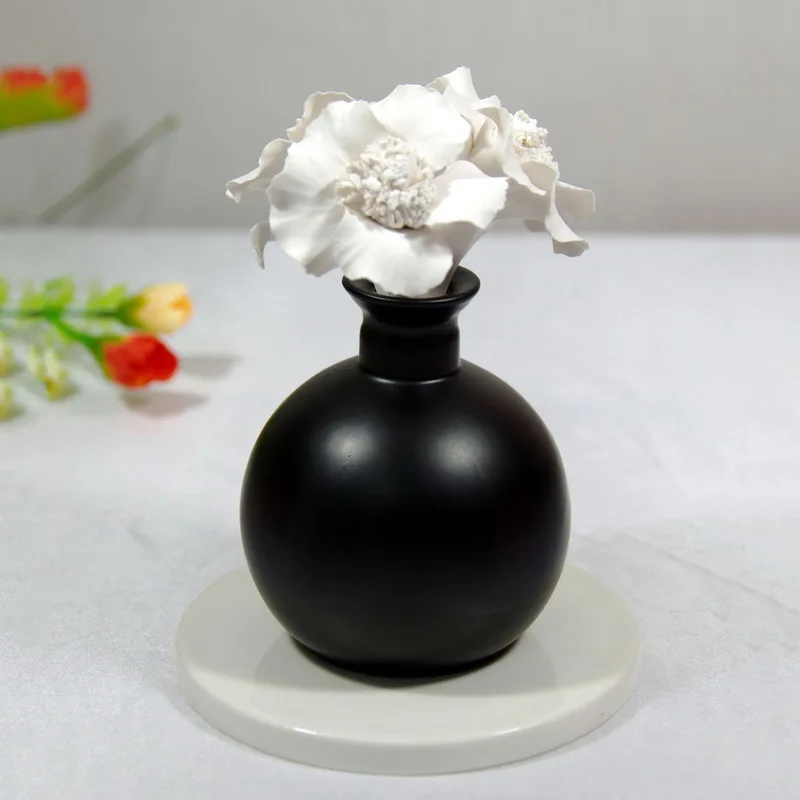 

Black ceramic round bottle oil diffuser essential with white plaster flower