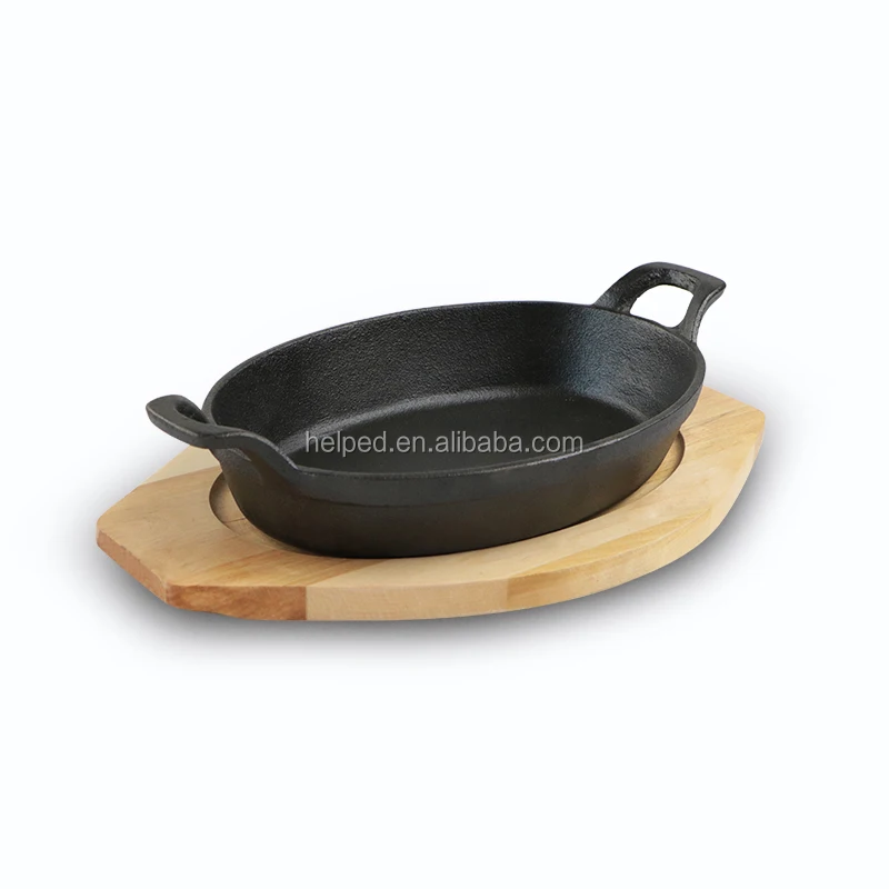 

mini cast iron oval cooking pot cookware with wooden base plate