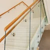 Solid wood box precast floating staircase with standoff glass railing