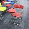Folding lecture chair with writing pad