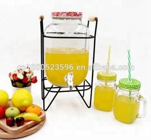 Image of clear or decorated glass mason jar beverage juice dispenser with screw tap