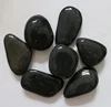 Natural pebbles polished black river rocks