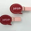 Special design red printed pegs with red round shape adhered above custom printed clothespin pegs
