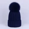 Girls knitted bobble pattern beanie hat with satin lining.