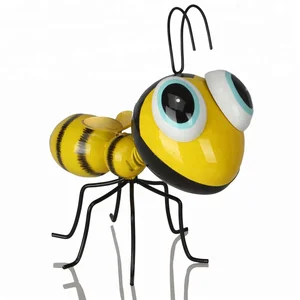 Image of Decorating Outdoor Garden With Folk Art Metal Bee Ornaments