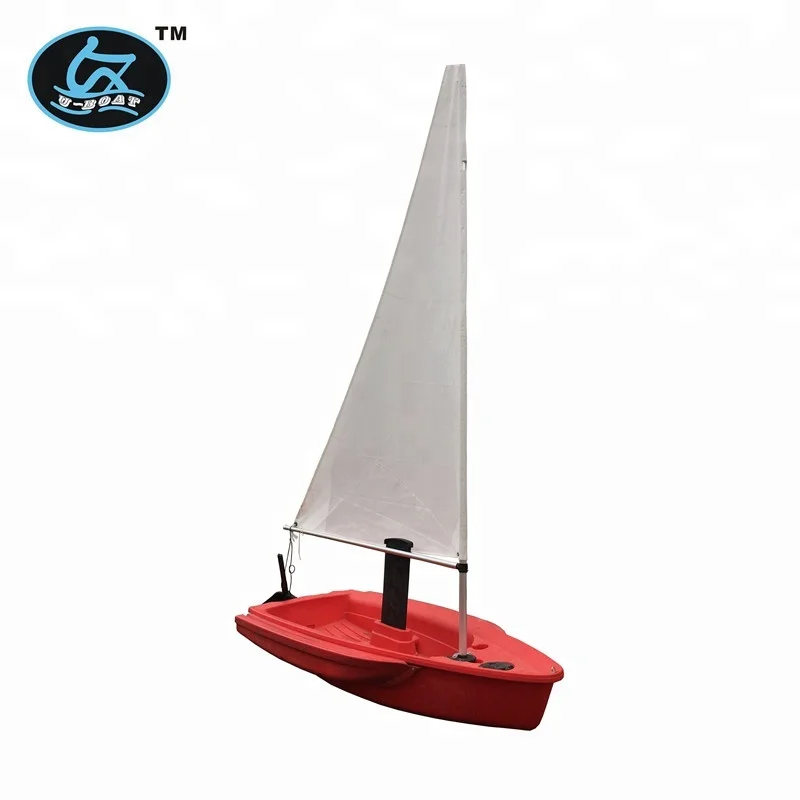 
small optimist student sailboat sails with outrigger 