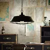 Industrial black cage pendant lighting interior with edison bulb for shop or bar counter