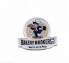 custom individiality logo BAKERY BROKERS merrow border woven patch