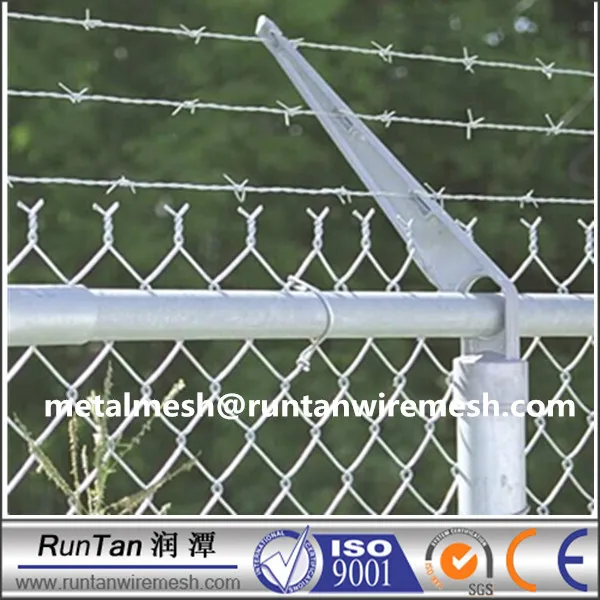 barbed wire on top of fence
