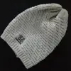gray winter warm knitting beanie with especial grain and letter rubber