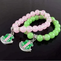 

Pink and Green crystal bead stretch Greek Sorority AKA shield charm bracelet Jewelry