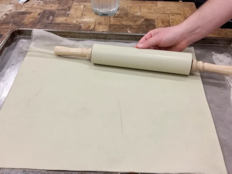 Rolling clay sheet with guide sticks for even thickness