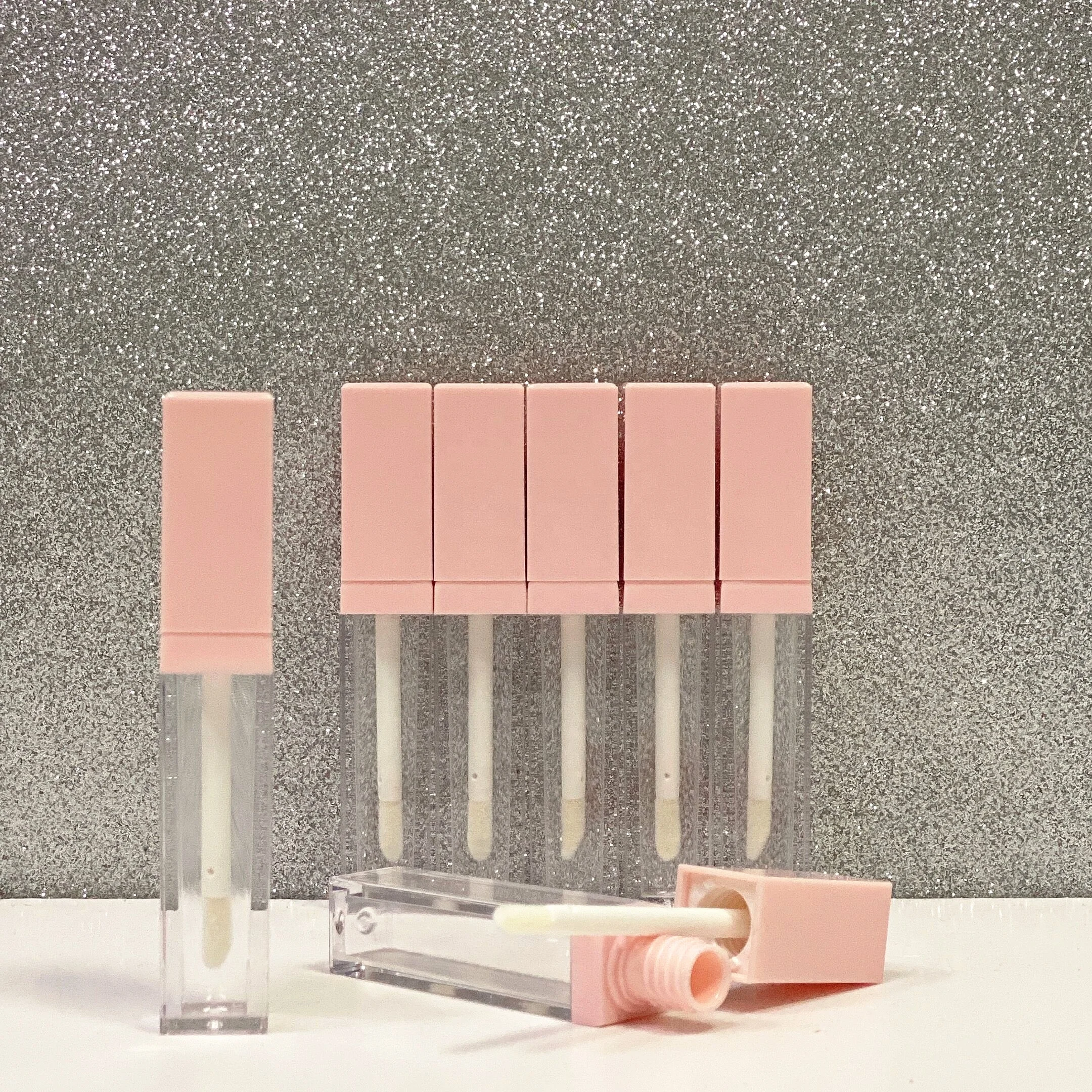 

5.5ml Jinlan Wholesale Empty Pink Cap Transparent Square Lip Gloss Tube Container with Black Neck