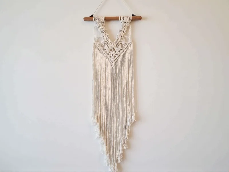 Handmade macrame wall hanging with wooden dowel